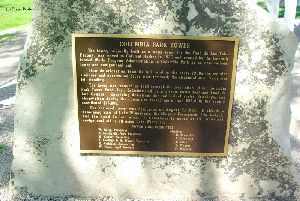 Historical plaque on a rock near the tower.