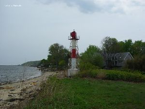 A rugged beach stands in front of the tower.