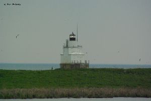 Lighthouse in distance, light lit.