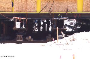 DURING MOVE: Workers converge underneath the tower.