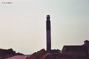 The lighthouse silhouetted against the sky.
