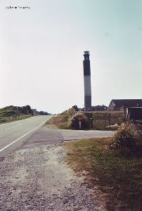 The lighthouse fenced into the Coast Guard grounds.
