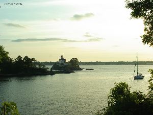 A sailboat and the lighthouse.