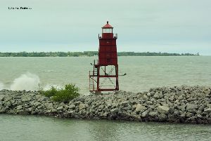Waves crash into the breakwater.
